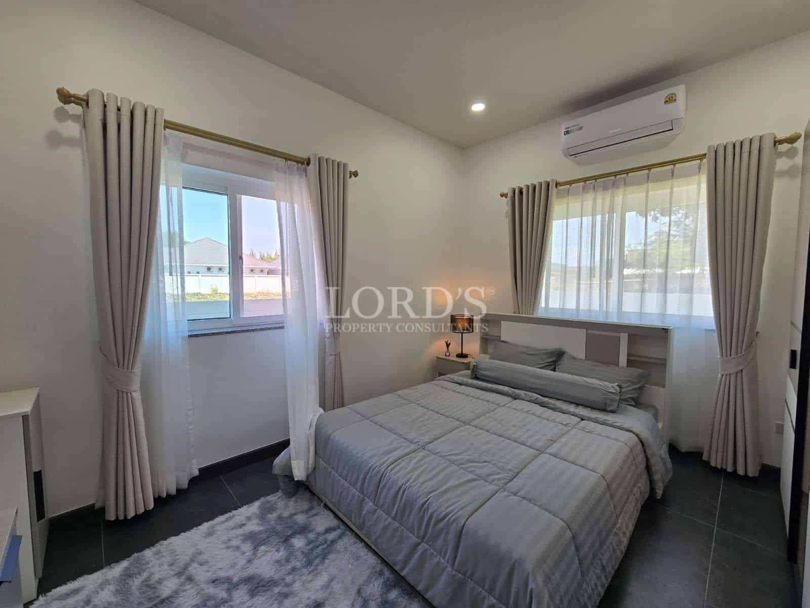 Modern bedroom with light curtains