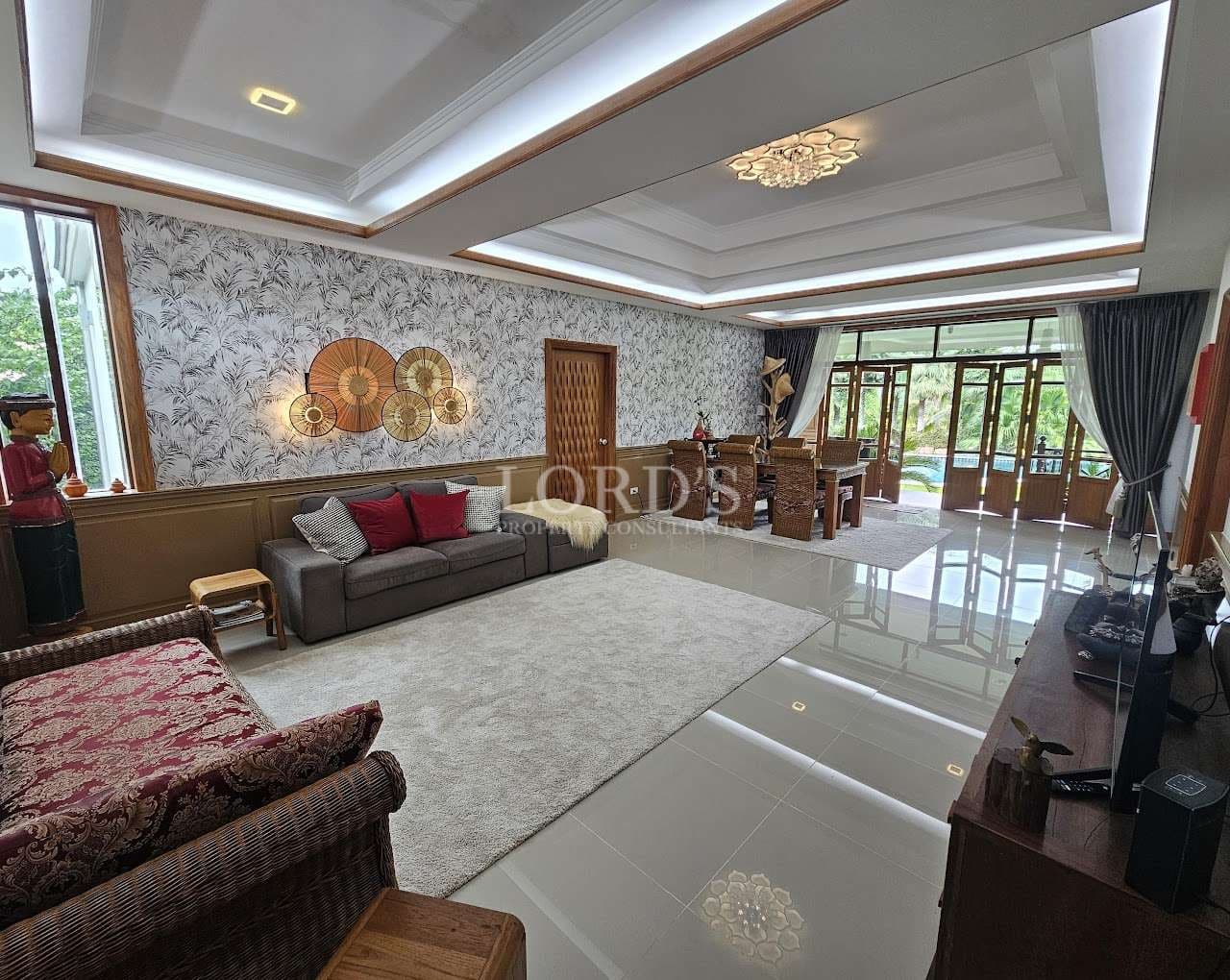 Spacious luxury living room with modern recessed ceiling lighting, patterned feature wall, glossy tiled floor, and open dining area with garden view