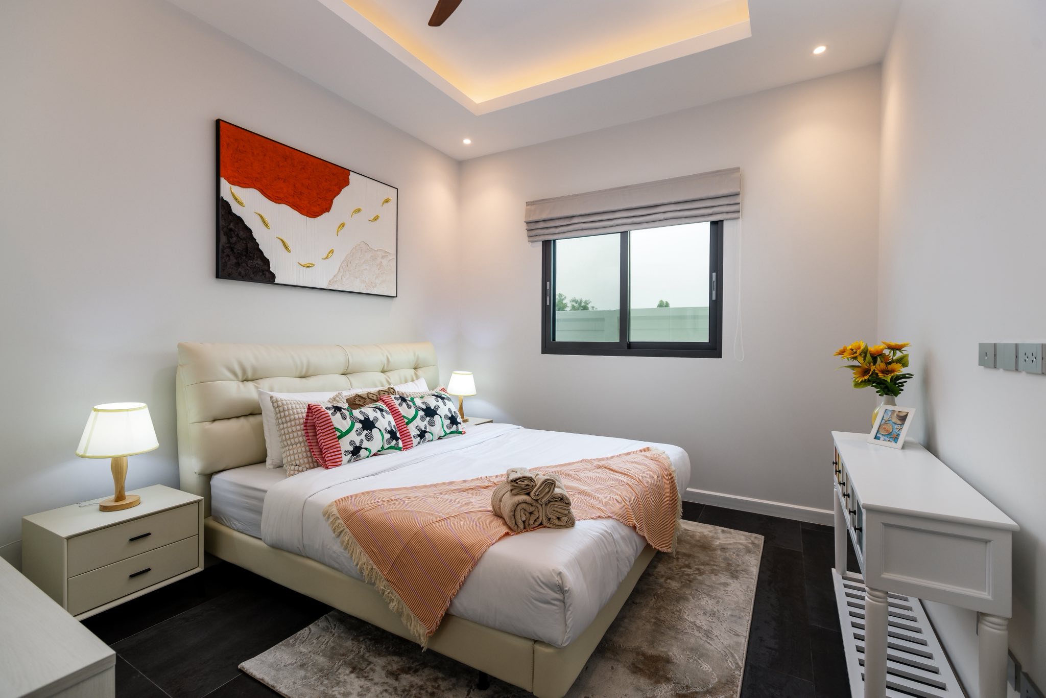 Modern cozy bedroom with queen-size bed, bedside lamps, minimalist décor, and soft ambient lighting.