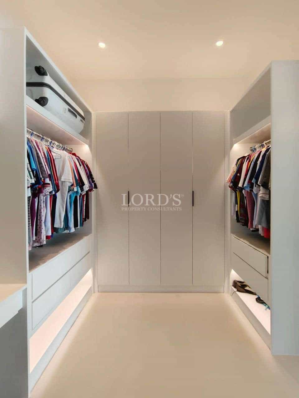 Modern closet with organized clothing racks