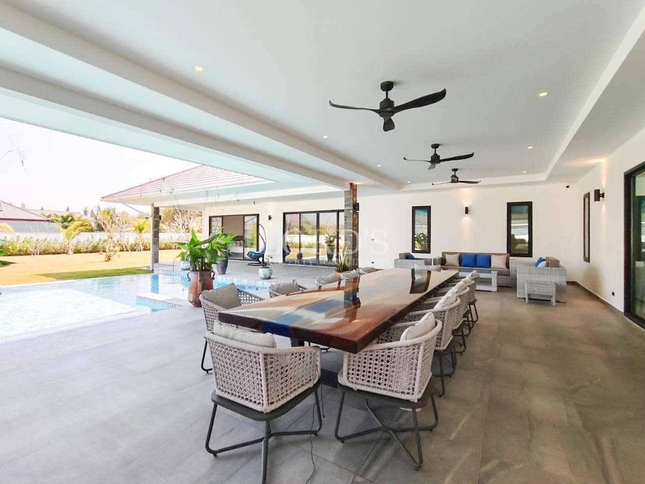 Modern outdoor dining area by pool