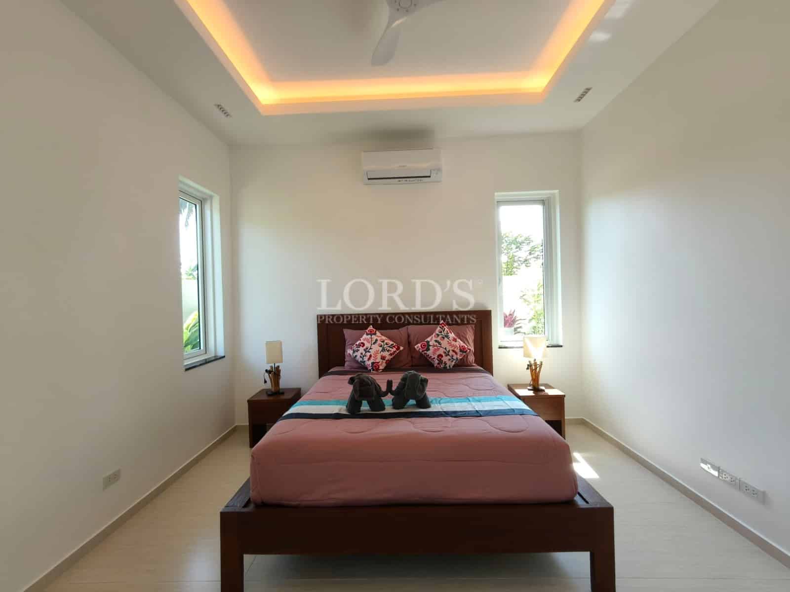 Modern bedroom with pink bedding.