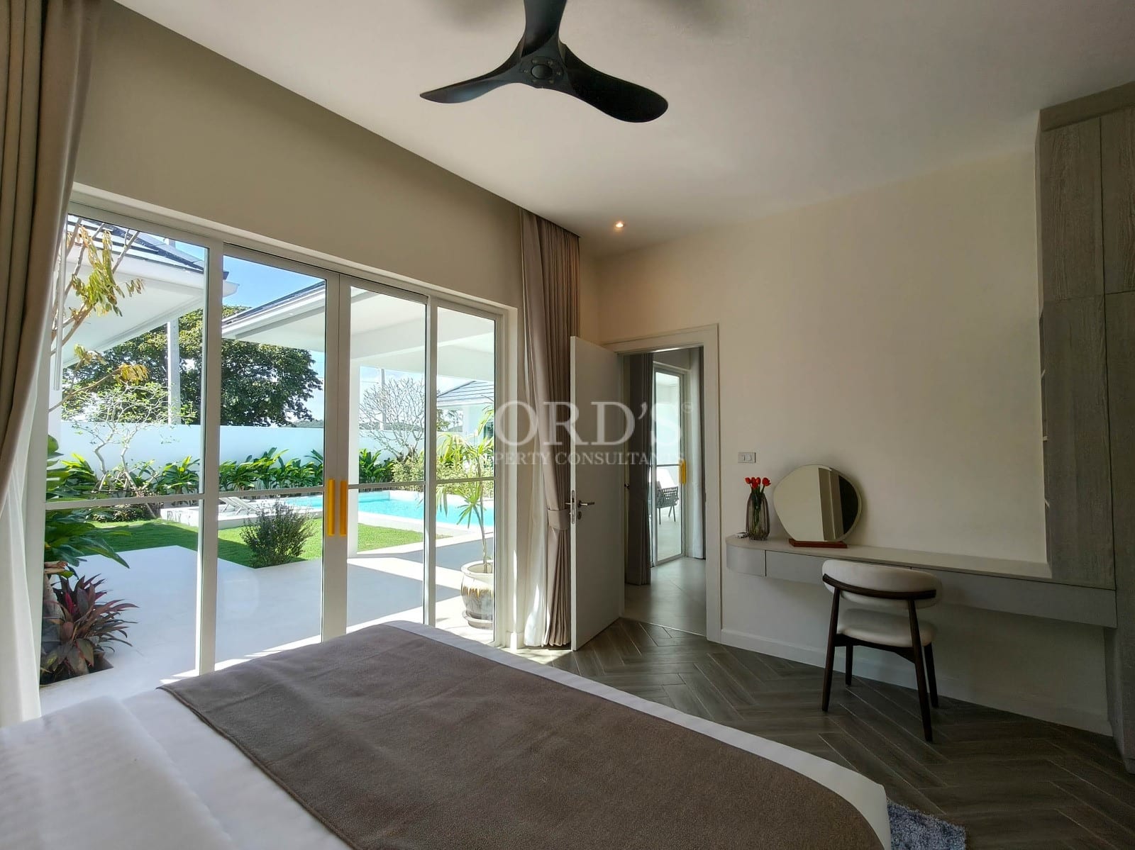 Bright modern bedroom with pool view