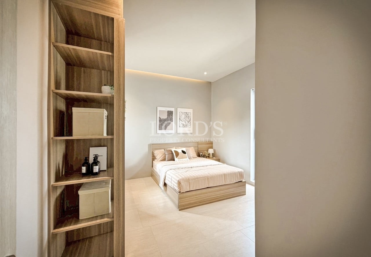 Minimalist bedroom view with wooden shelving, soft lighting, and neutral interior design.