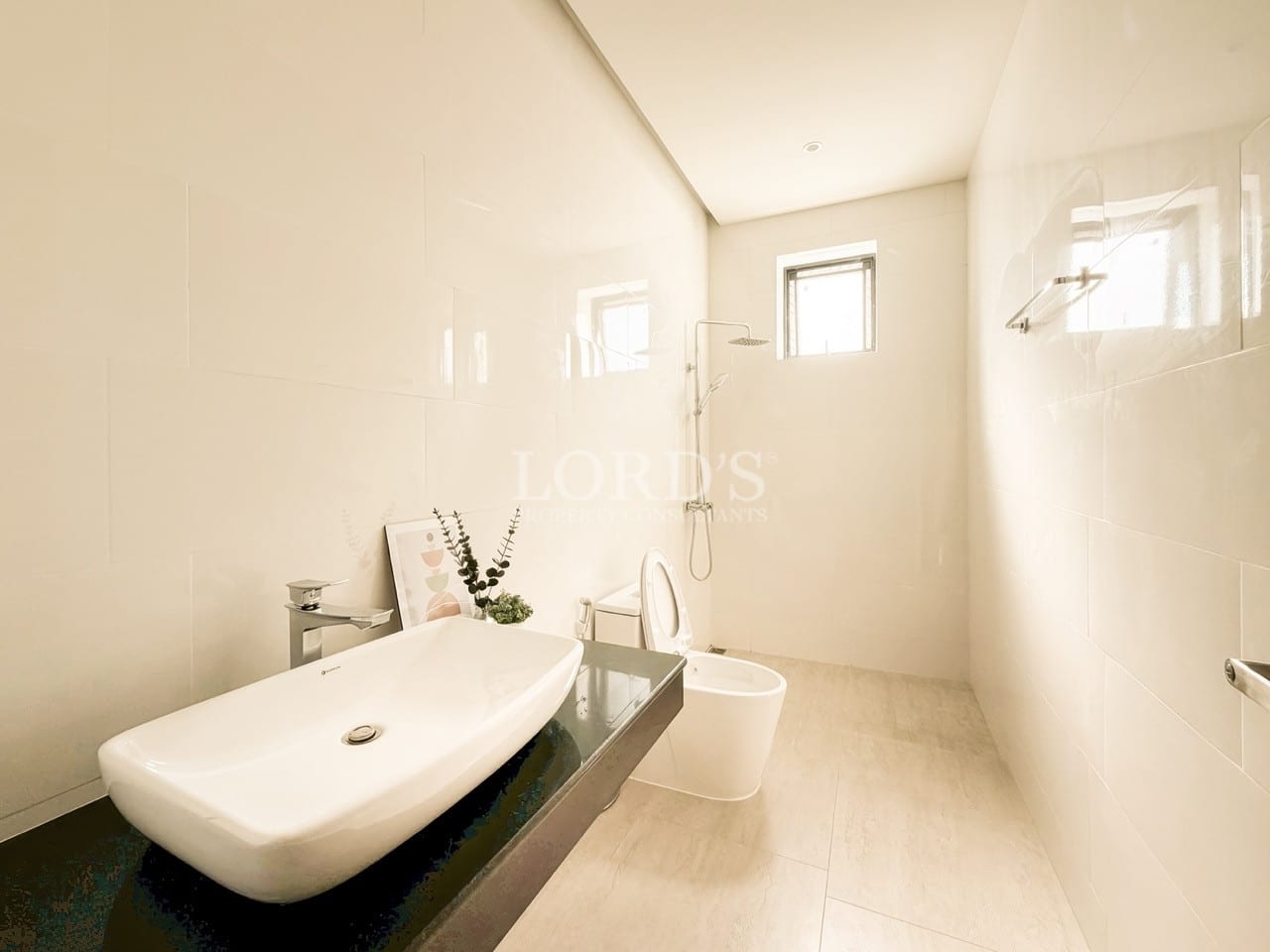 Minimalist modern bathroom with walk-in shower, floating vanity, and soft natural light.