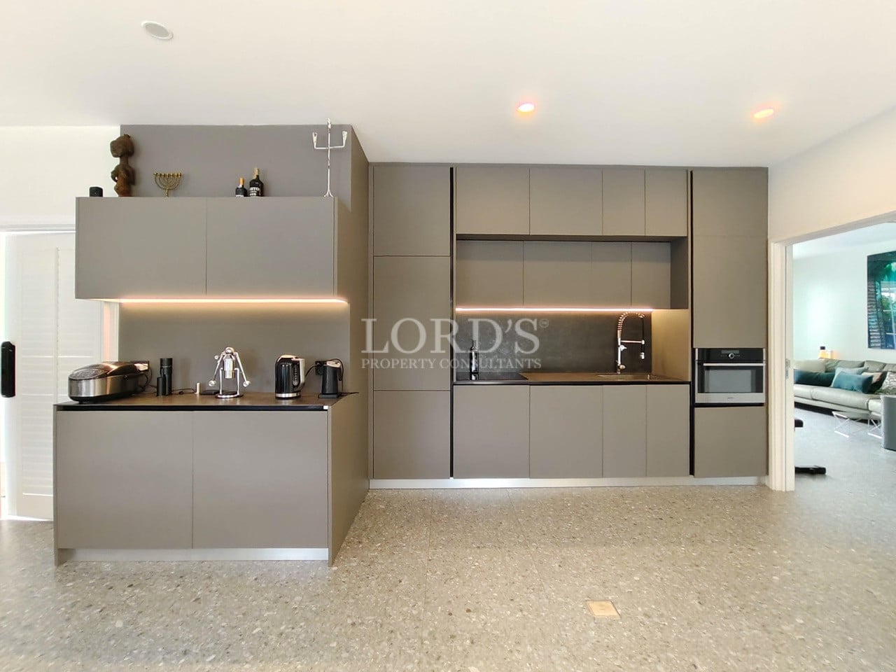 Modern fully equipped kitchen with sleek cabinetry, built-in appliances, and minimalist design.