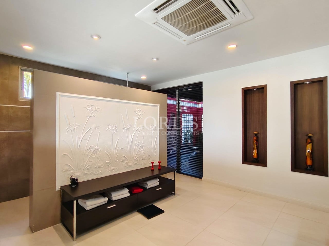 Modern villa bathroom entrance with decorative wall panel and minimalist design.