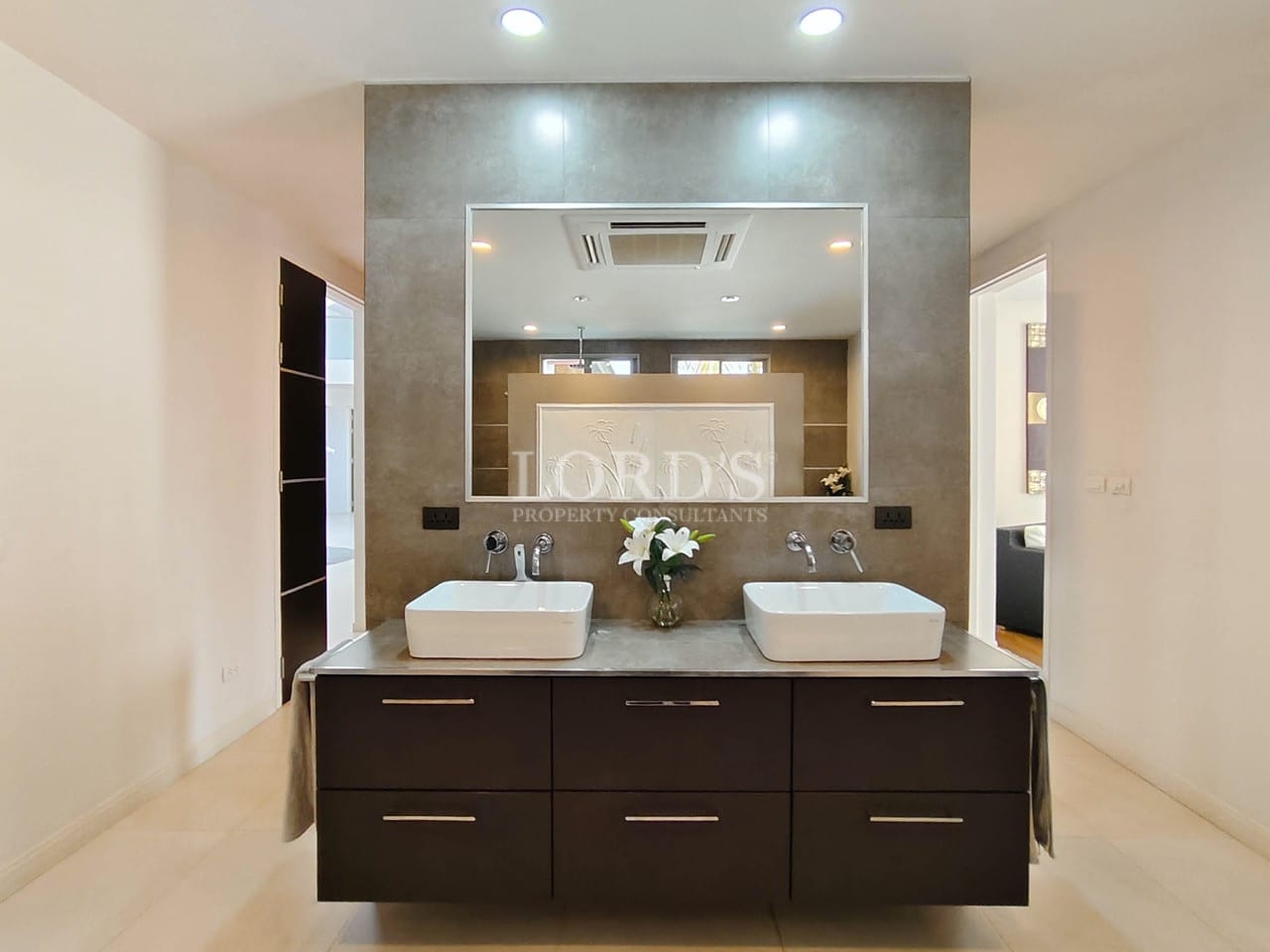 Luxury villa bathroom with double sink vanity and modern mirror design.