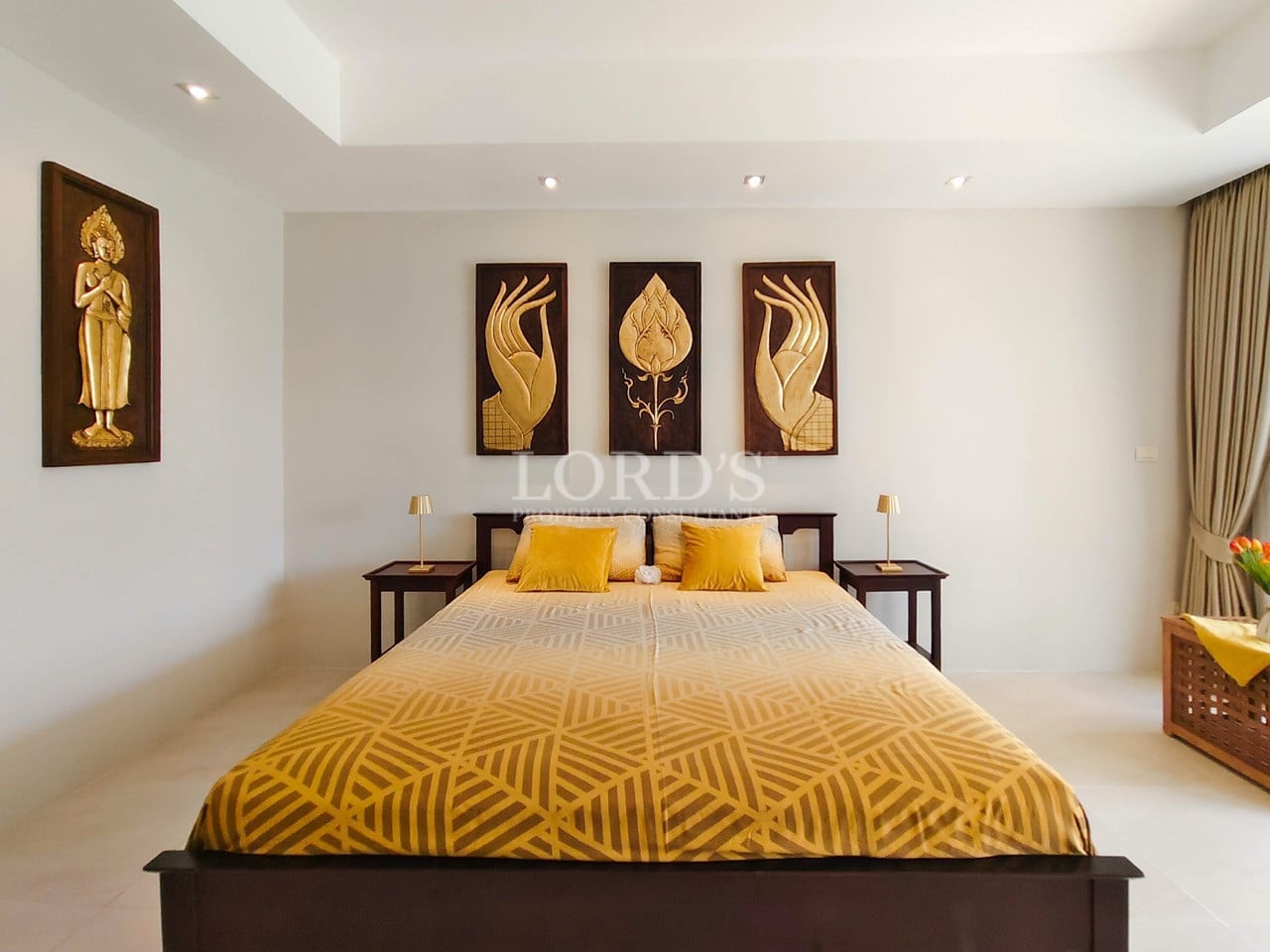 Elegant villa bedroom with king-size bed and decorative wall art.