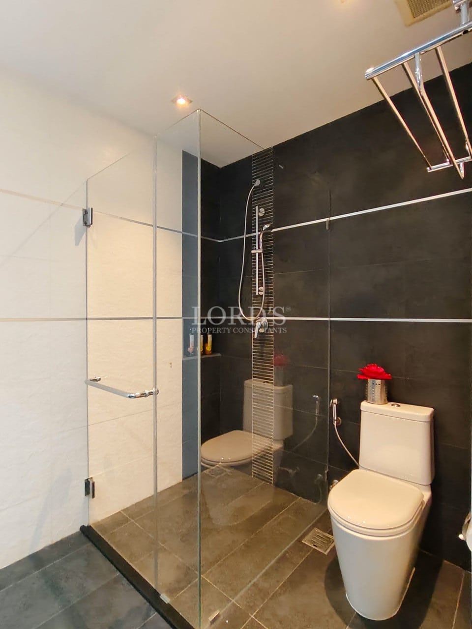 Modern villa bathroom with walk-in glass shower and contemporary fixtures.