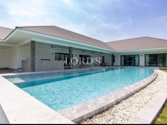 Modern luxury villa with large private swimming pool and covered outdoor patio