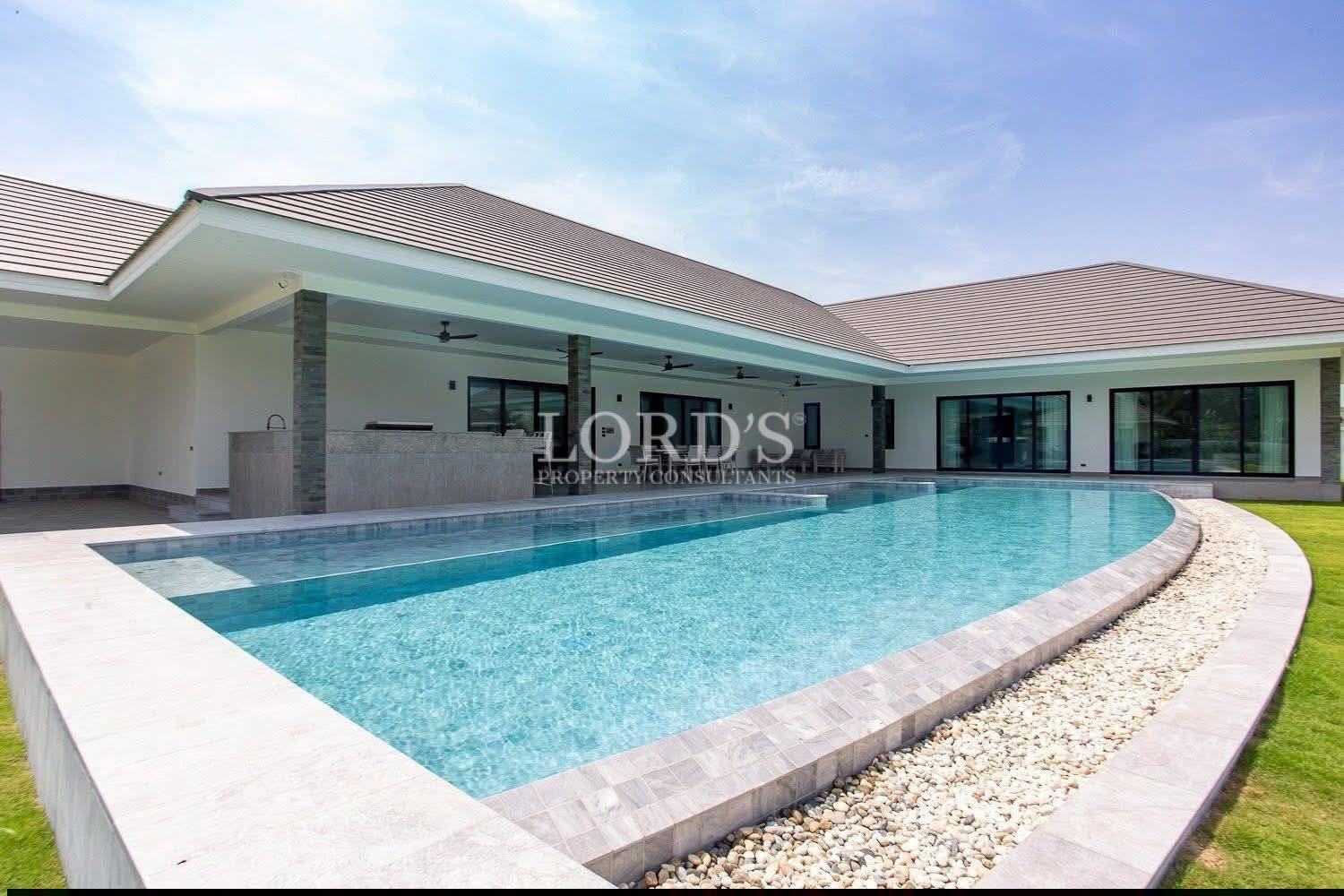 Modern luxury villa with large private swimming pool and covered outdoor patio