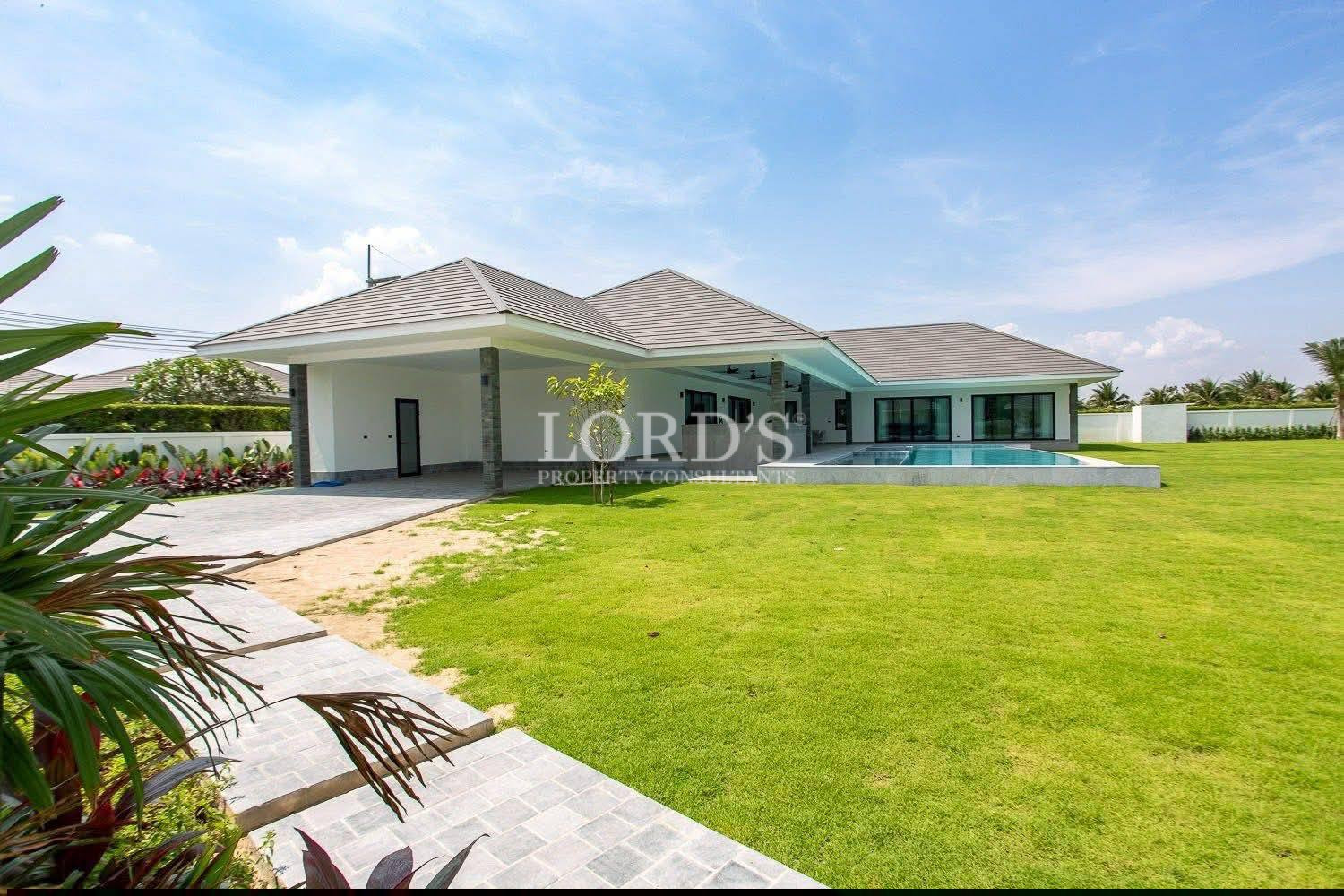 Modern single-story luxury villa with large garden, private swimming pool, and covered patio