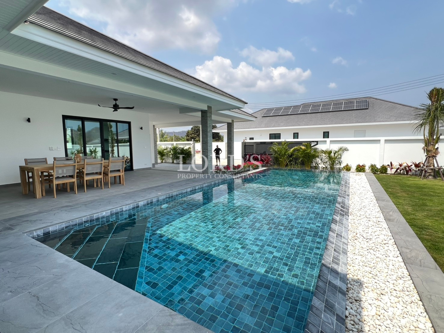 Modern villa with private swimming pool and covered outdoor dining terrace