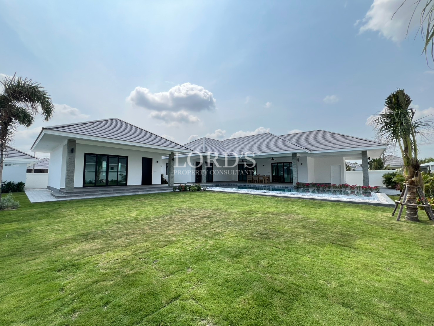 Modern single-story luxury villa with private swimming pool and large green garden