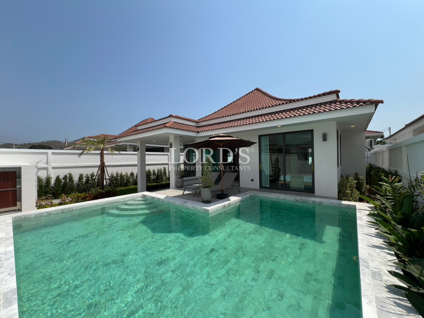 Modern single-storey villa with private swimming pool and covered outdoor patio.