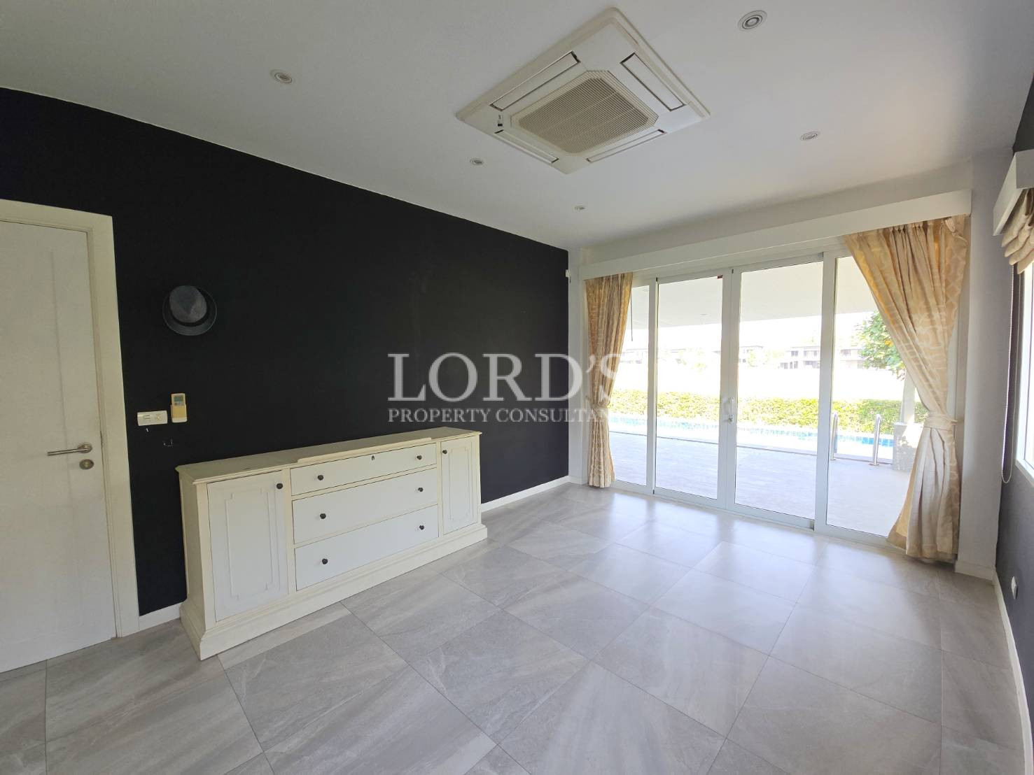 Living room with wide windows and dining area