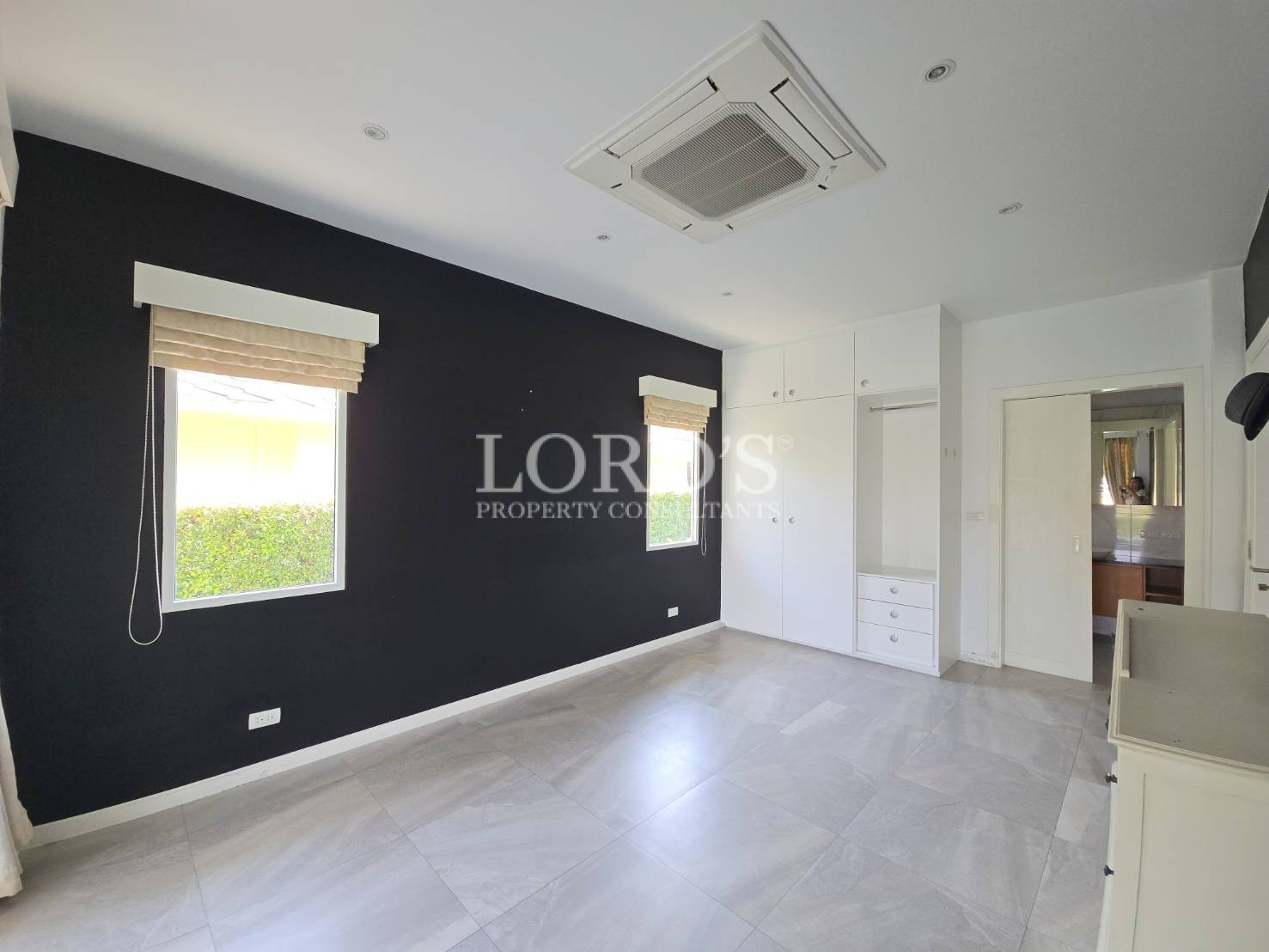 Empty room with black accent wall