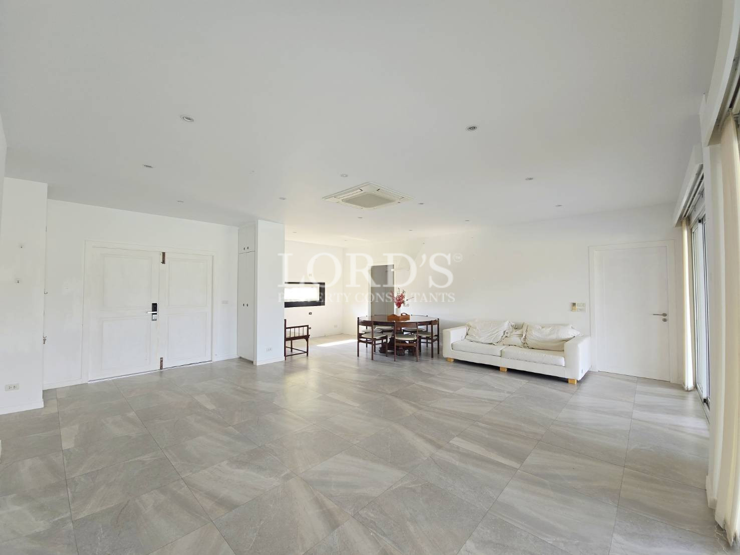 Large empty living room with tiled floor