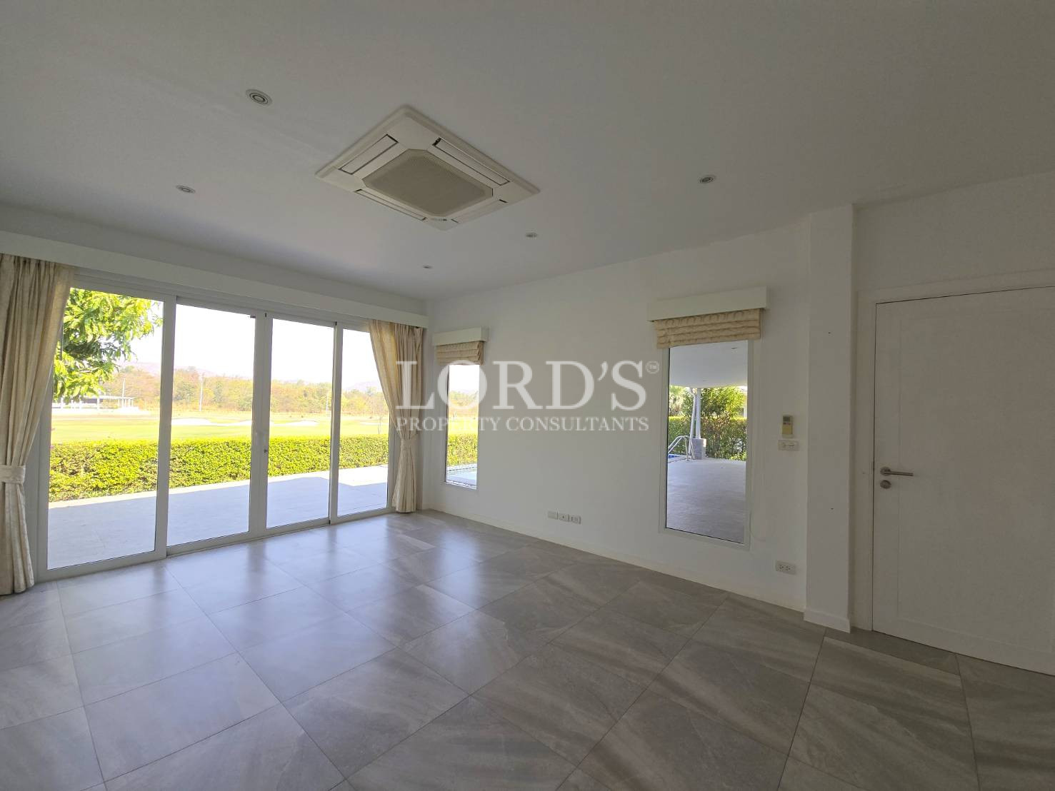 Corner room with large windows and curtains