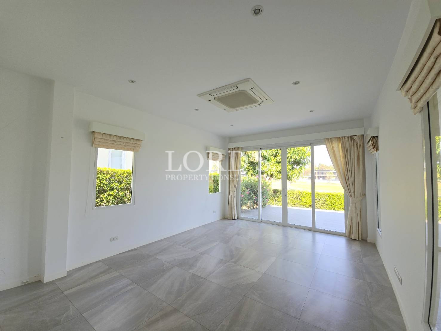 Empty living room with large windows
