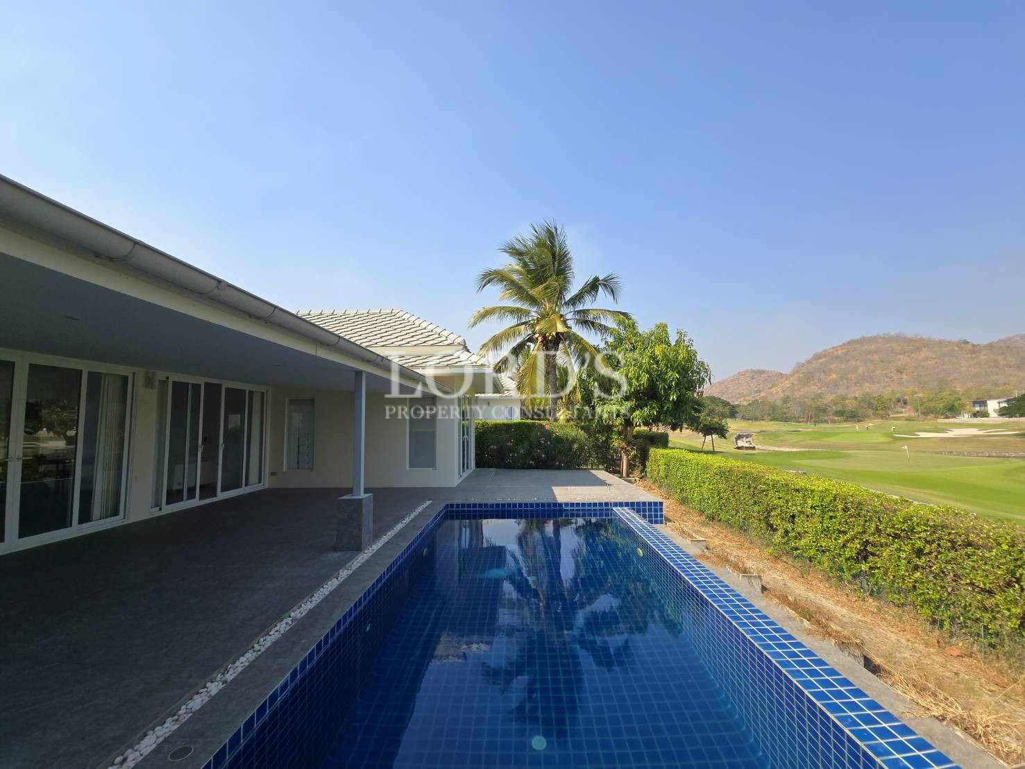 Swimming pool with reflection of house