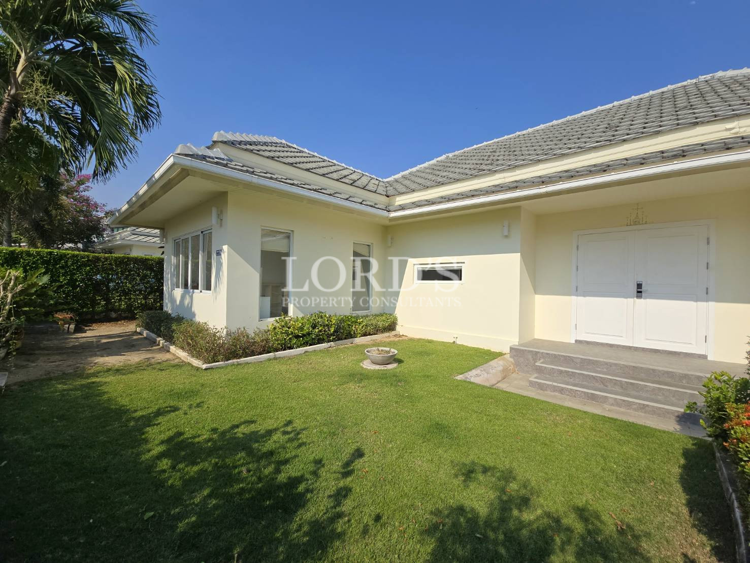 House exterior with lawn and garden