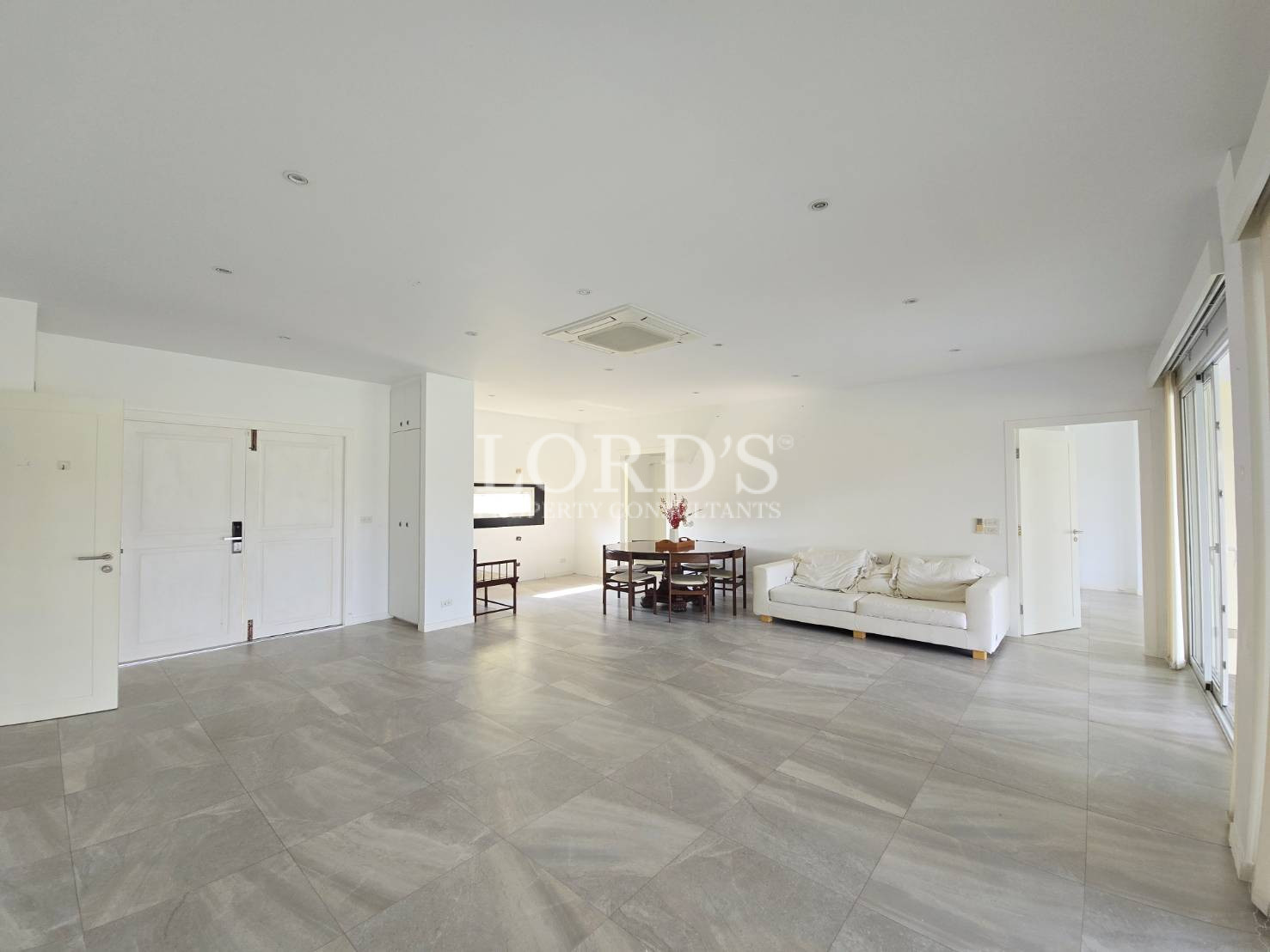 Large empty living room with tiled floor