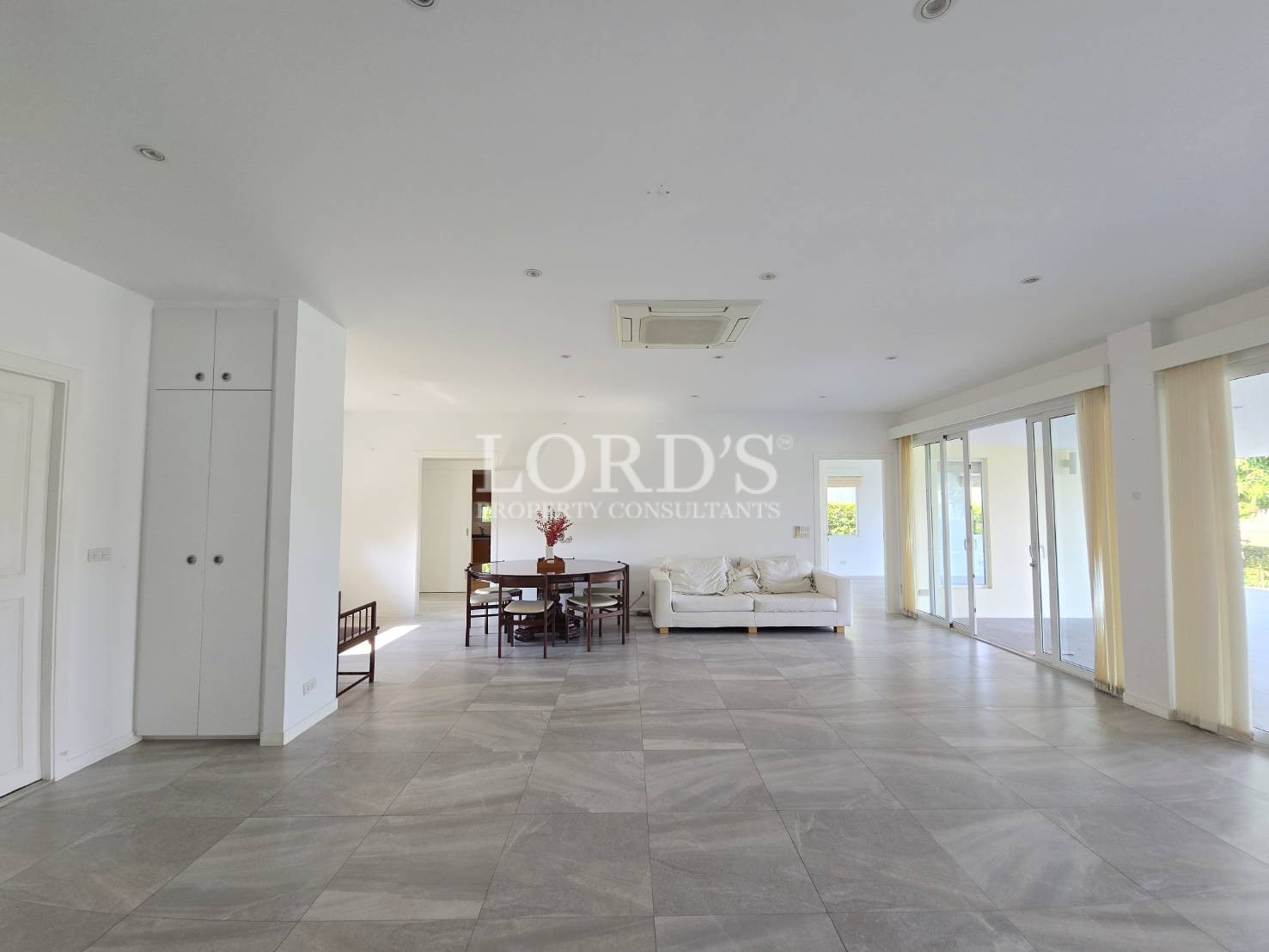 Large empty living space with tiled floor