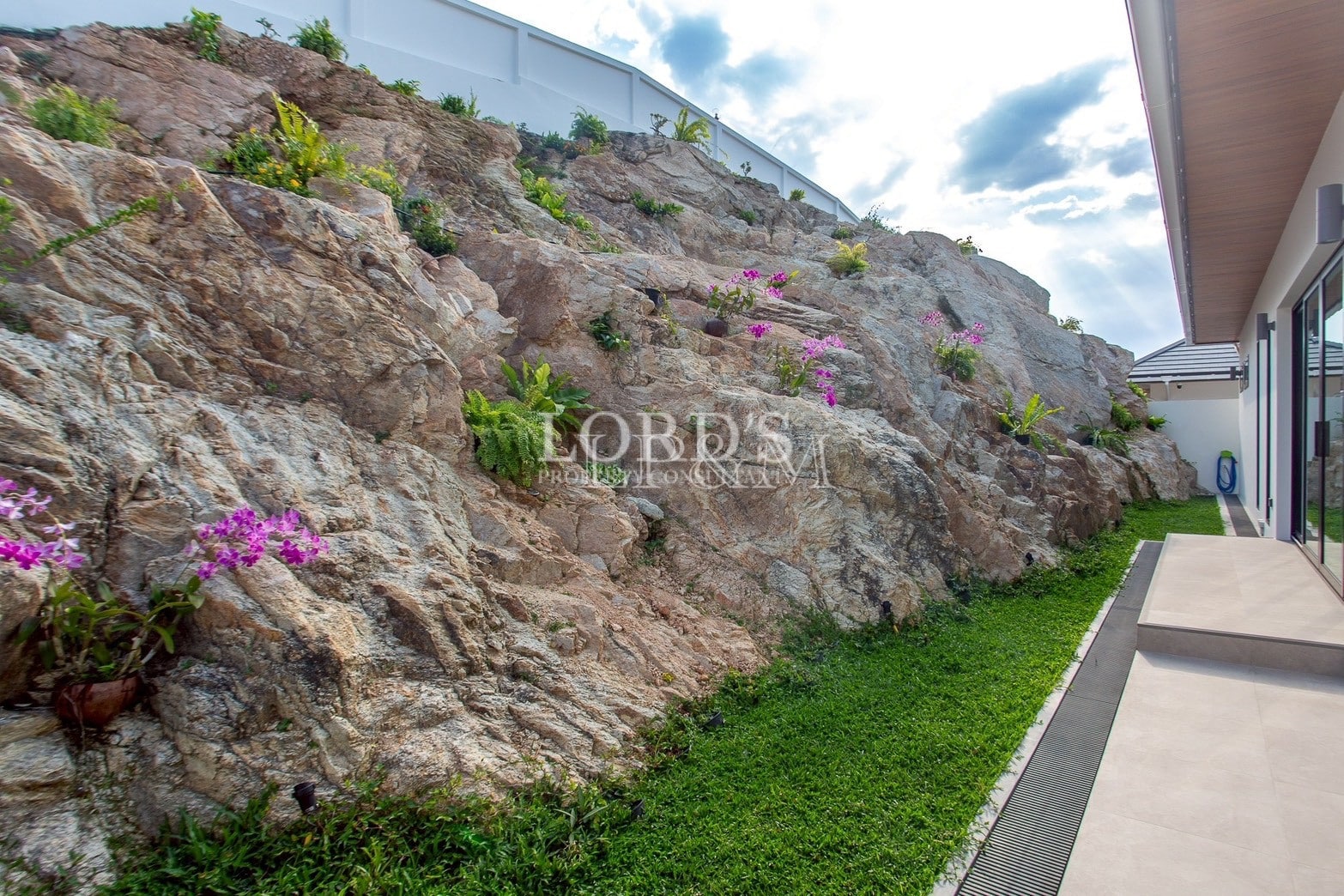 Rock garden beside villa wall