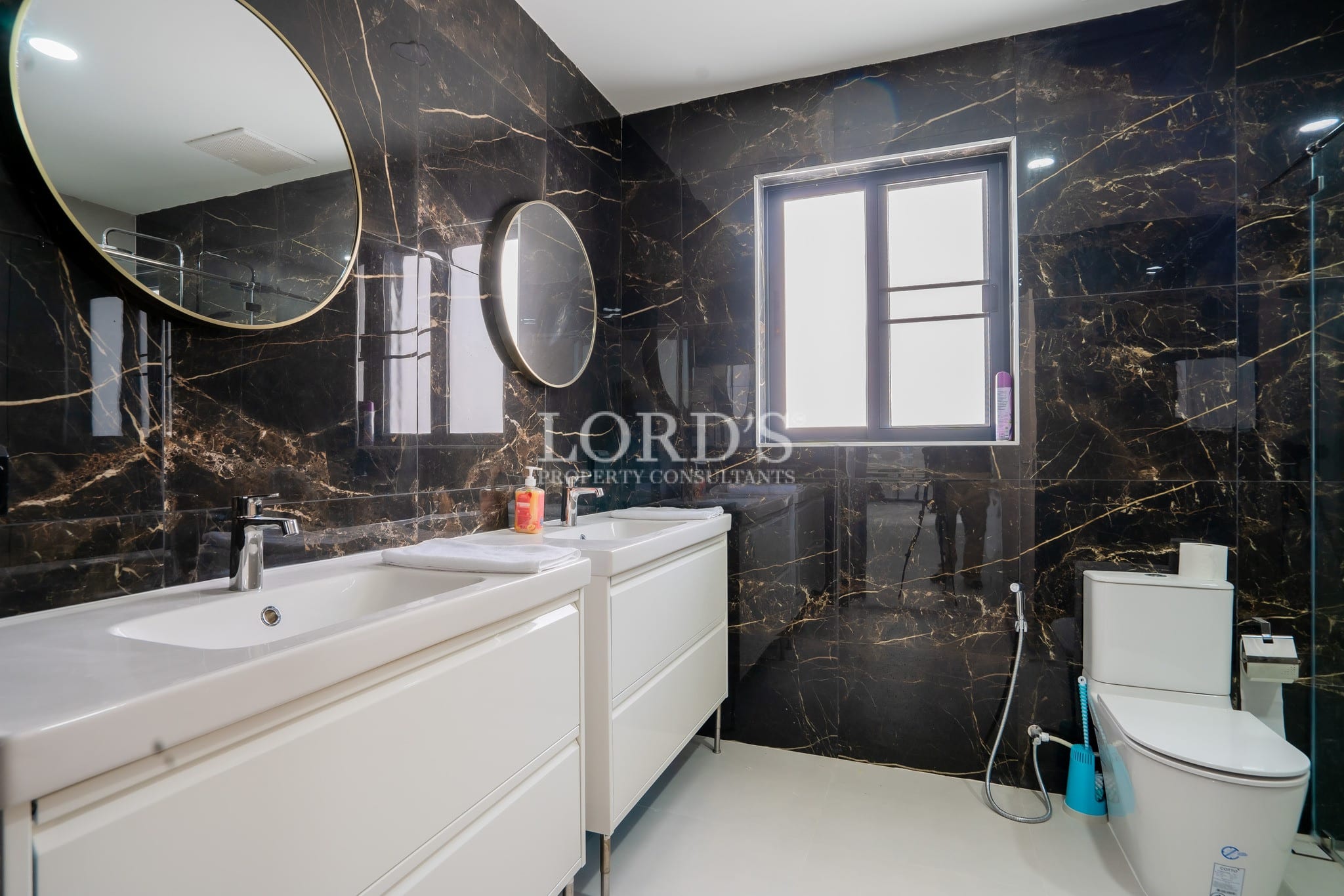 Bathroom with dark tile wall and sink