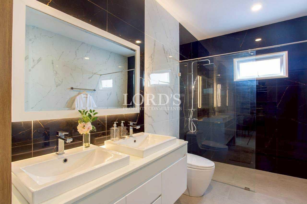 Bathroom with marble countertop and mirror