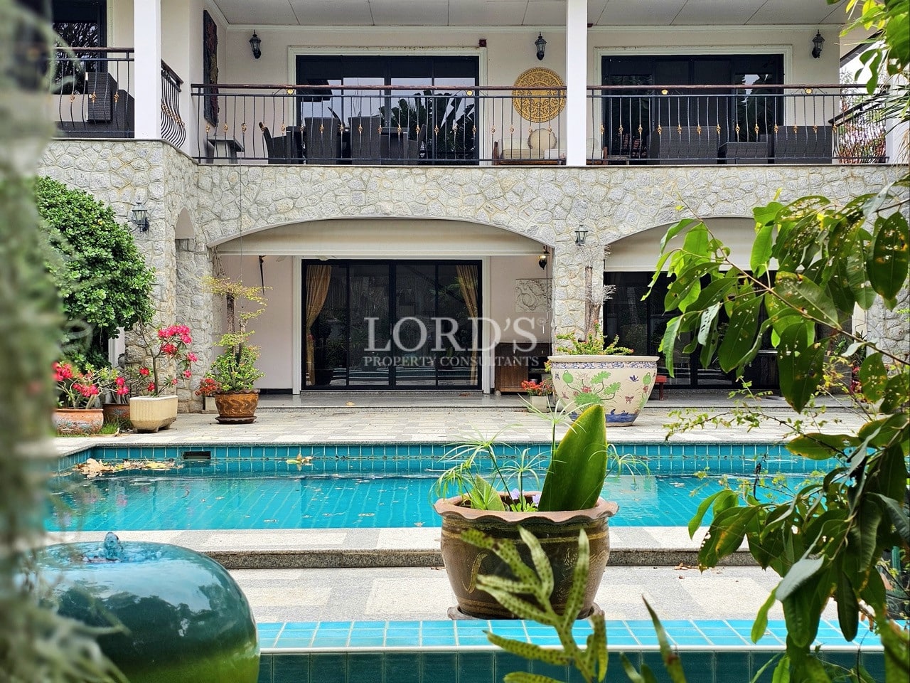 Luxury villa exterior with private swimming pool and tropical garden