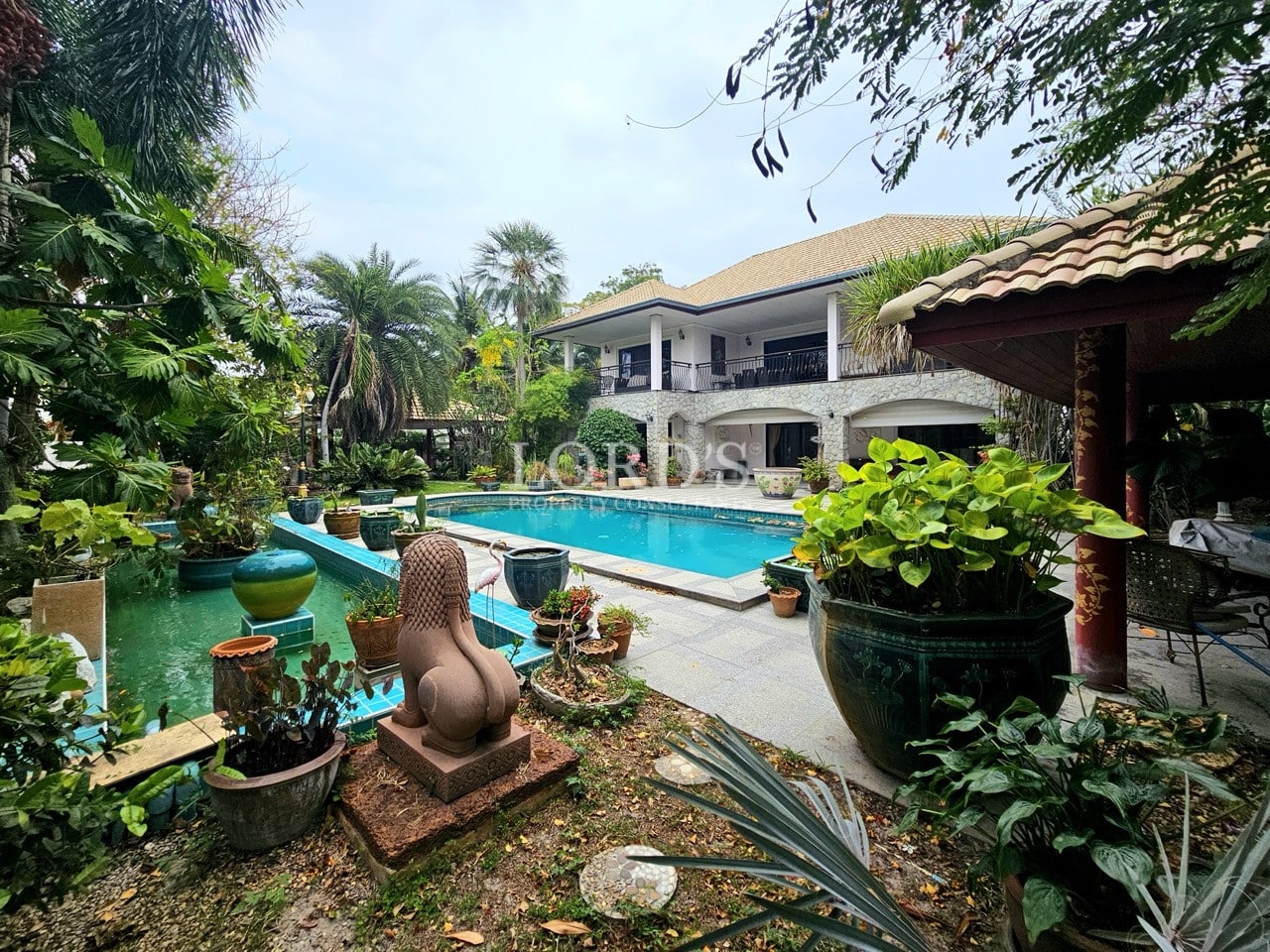 Large villa exterior with swimming pool and garden