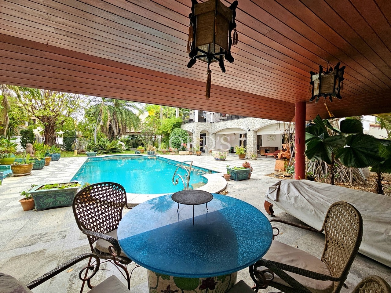 Garden statue with tropical plants near pool