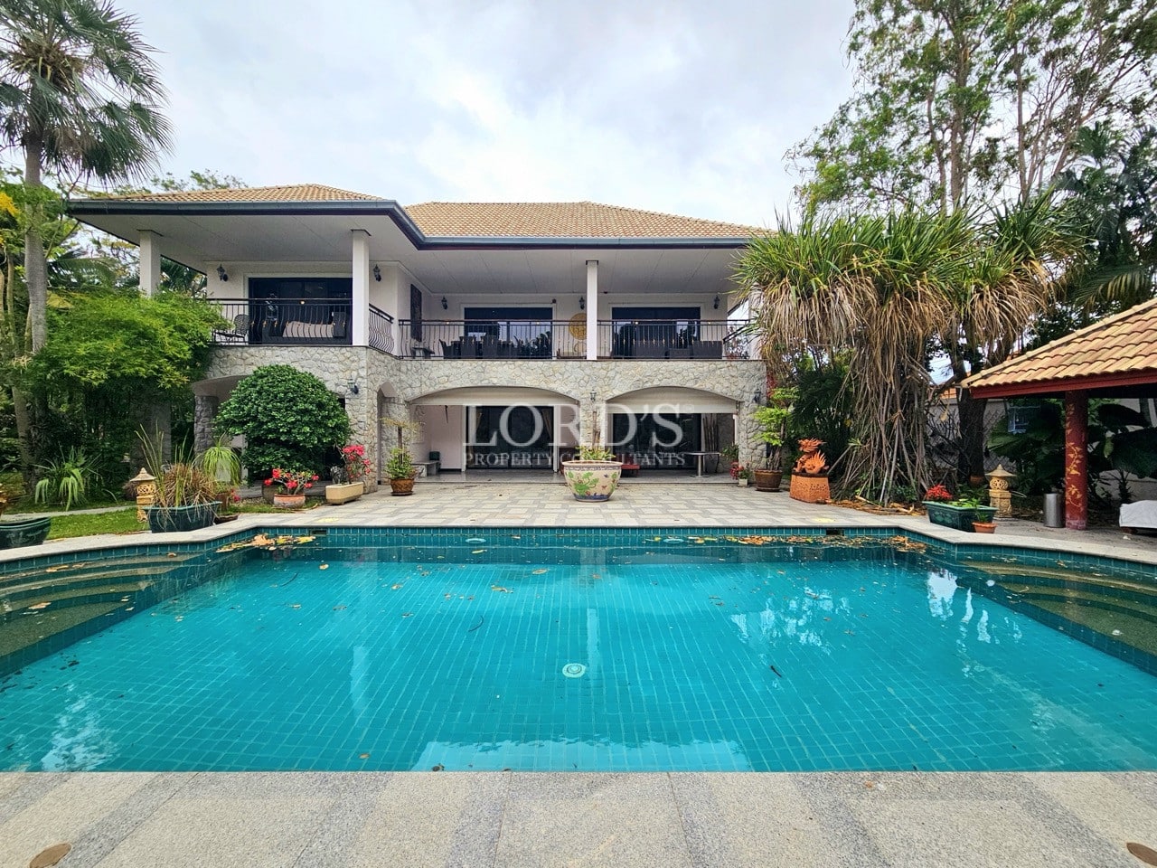 Decorative poolside water feature with plants