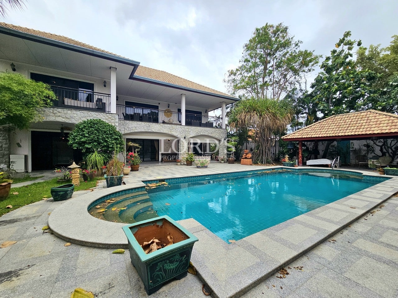 Large pool with surrounding greenery and lounge area