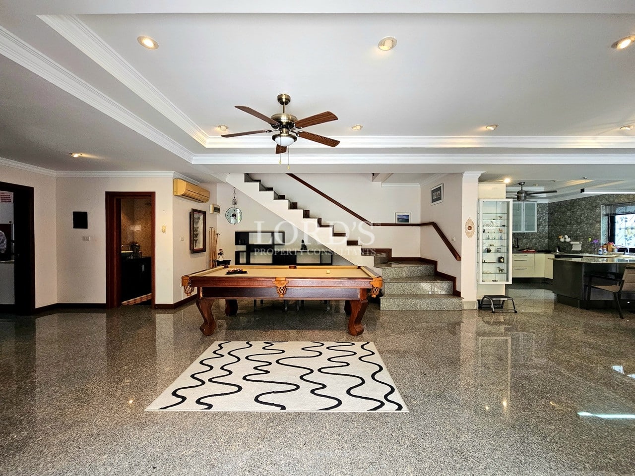 Living room with staircase and marble flooring