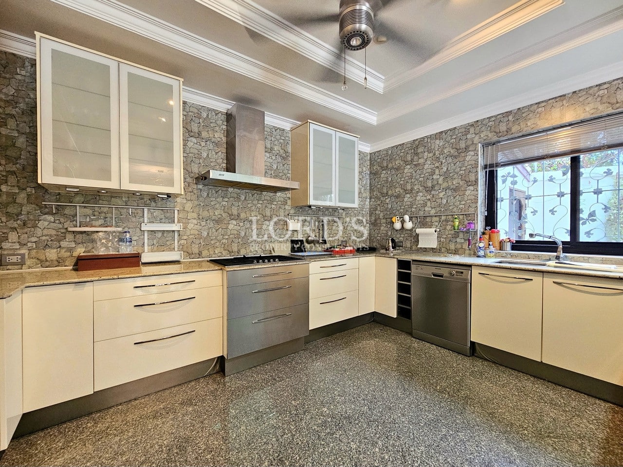 Luxury kitchen with stone backsplash and cabinets