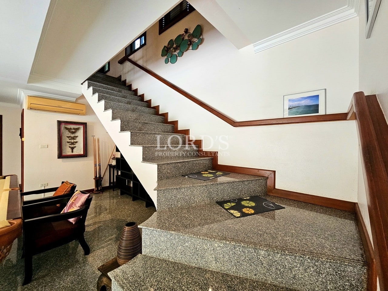 Interior staircase with stone steps and wooden railing