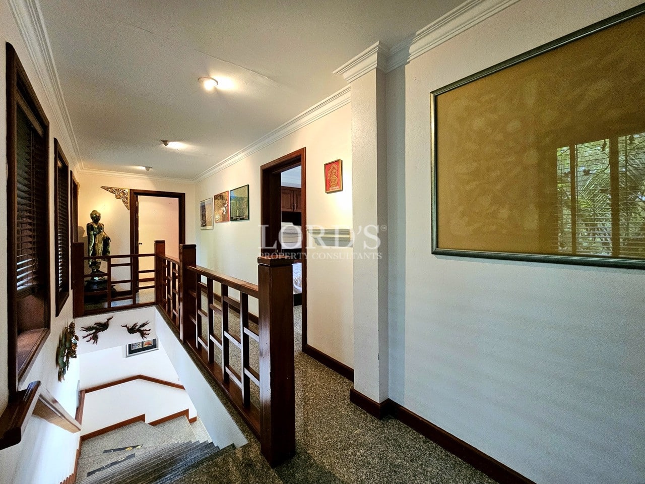 Bedroom with wooden bed frame and artwork