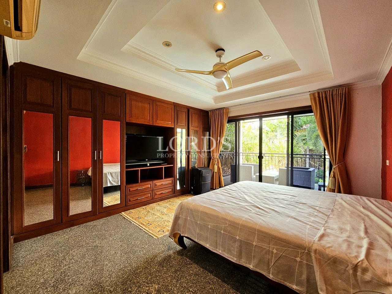 Bedroom with glass wardrobe and balcony doors