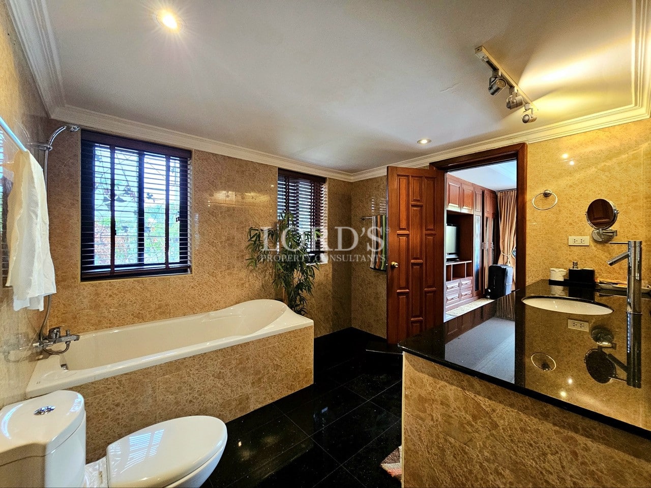 Spacious bathroom with bathtub and wooden vanity