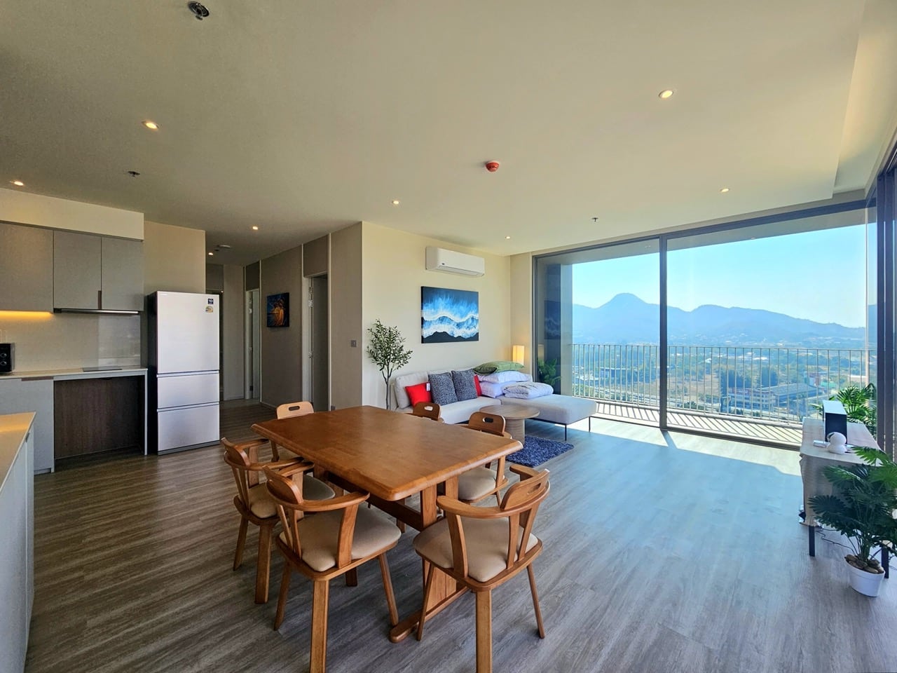 Dining area with wooden table and balcony view