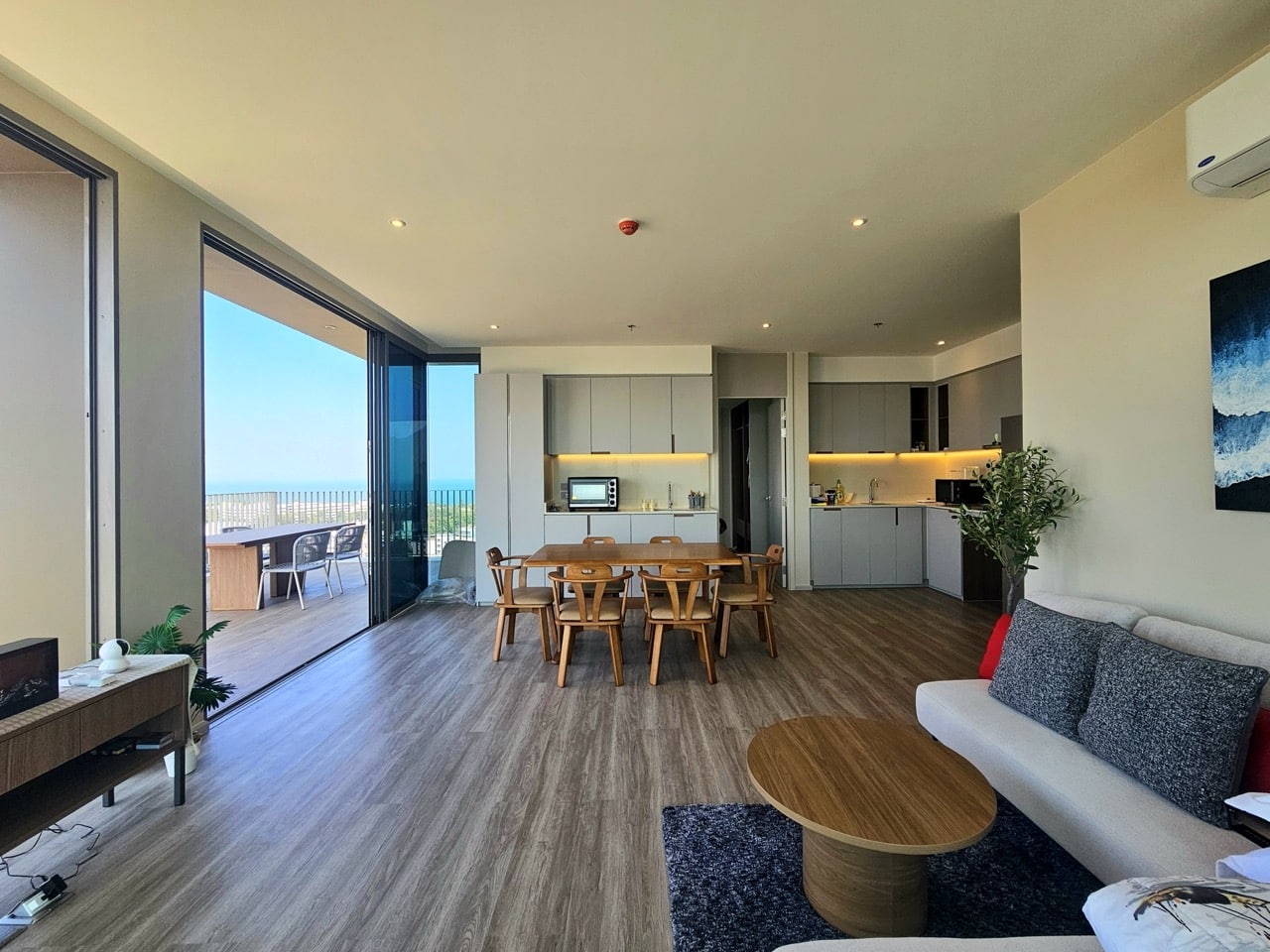 Open living room with balcony and dining area