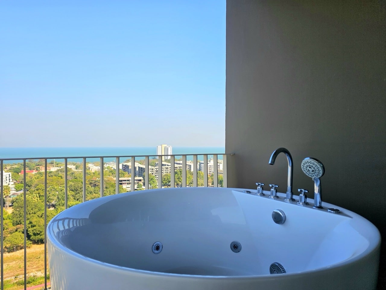 Bathtub with city view from balcony