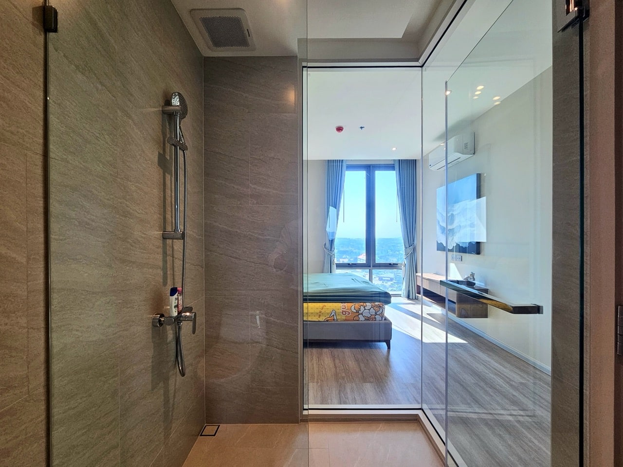 Bathroom with glass shower and wooden tiles