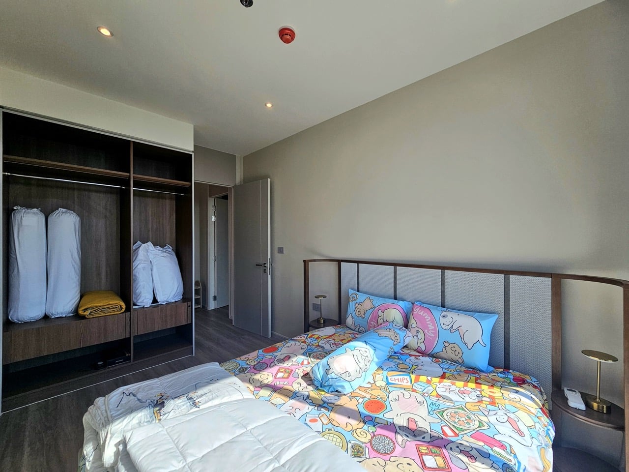 Bedroom with colorful bedding and large window