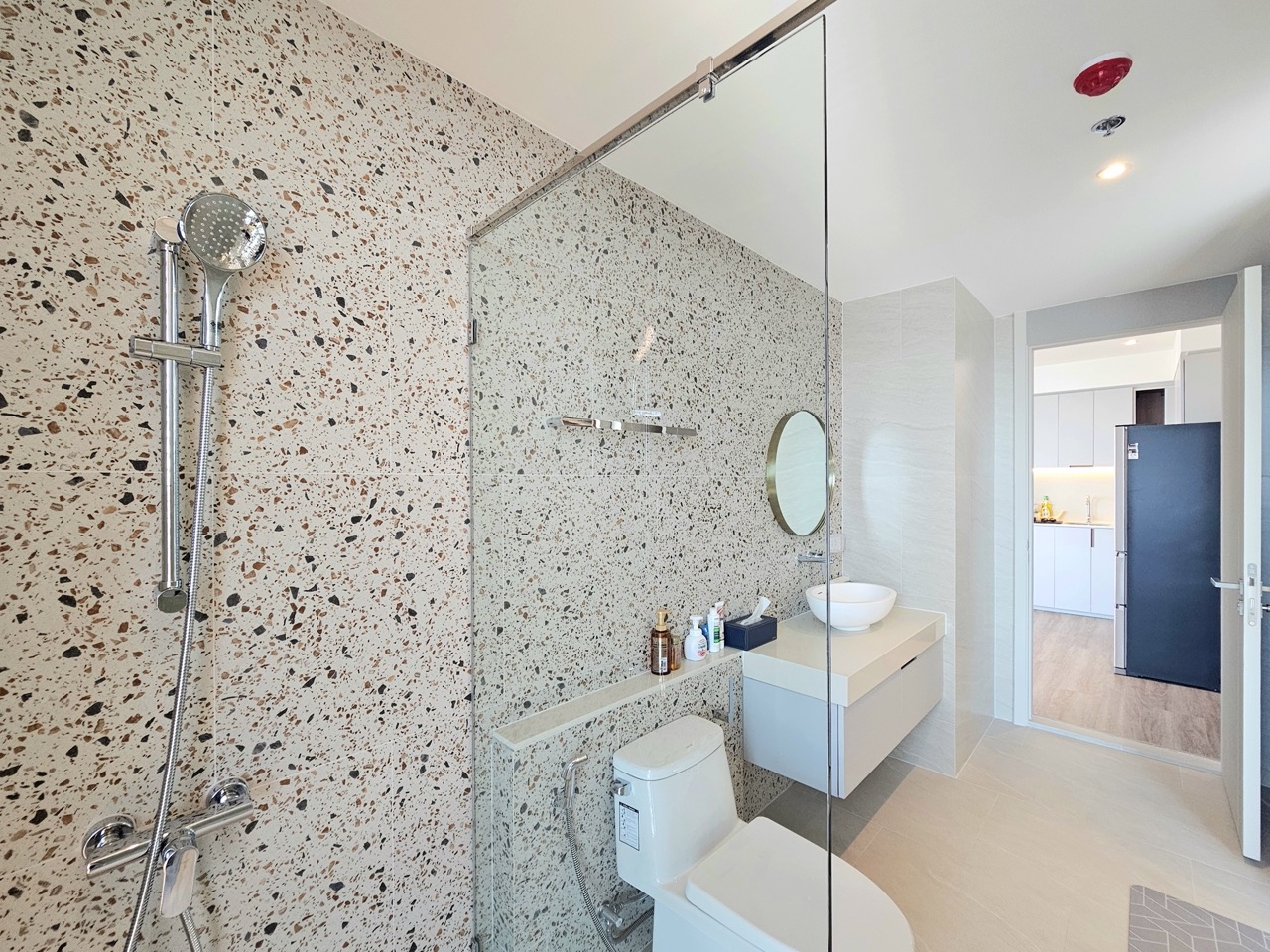 Bathroom with textured wall tiles and sink