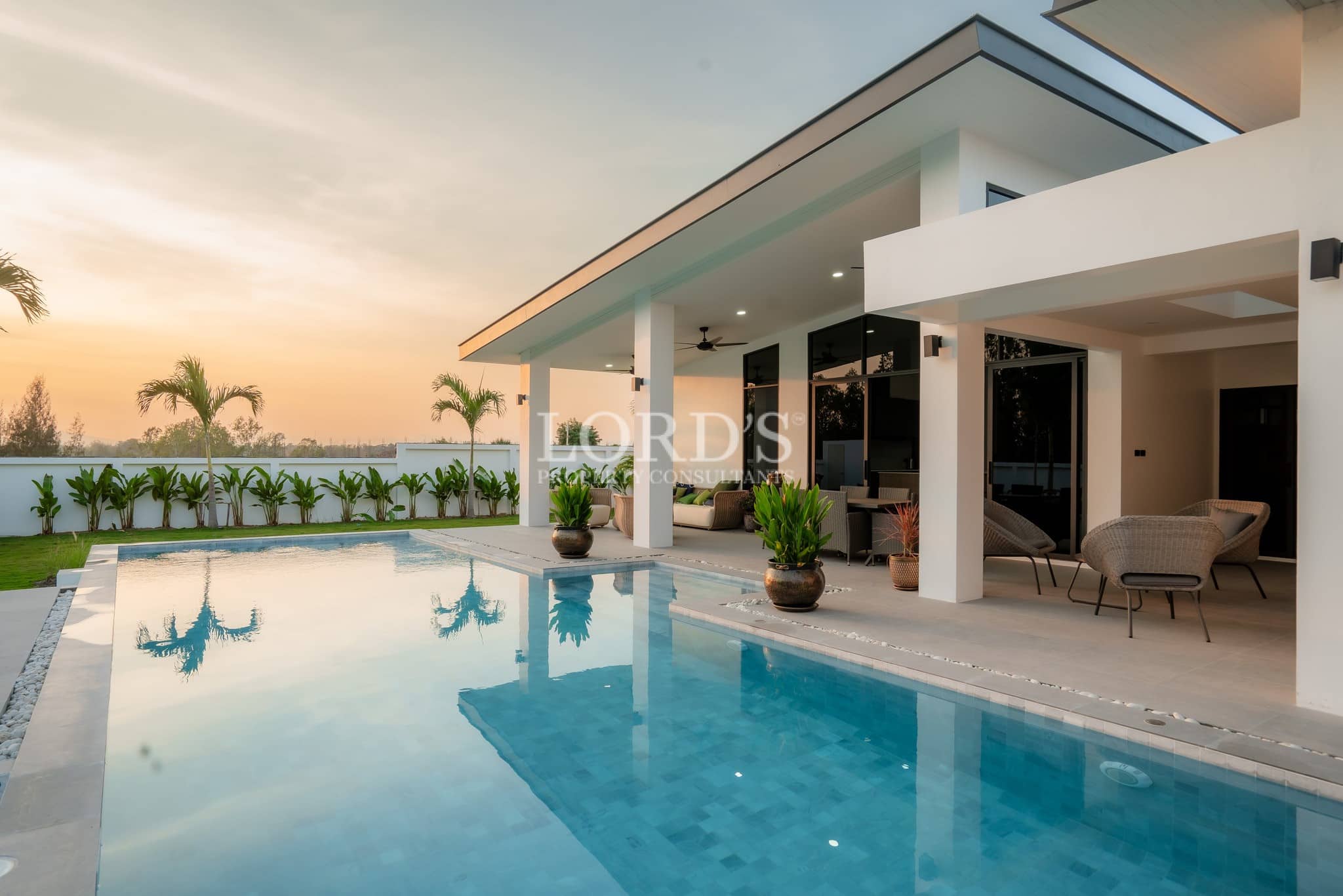 Luxury villa poolside exterior at sunset